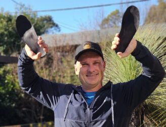 Patient with orthotics and recommended footwear by podiatrist