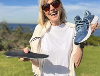 Patient with orthotics and recommended footwear by podiatrist