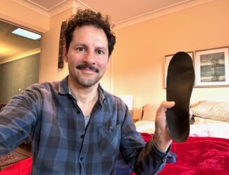 Patient with orthotics and recommended footwear by podiatrist