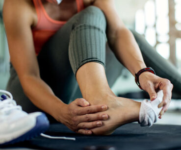 athletic woman injured her foot during workout