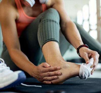 athletic woman injured her foot during workout